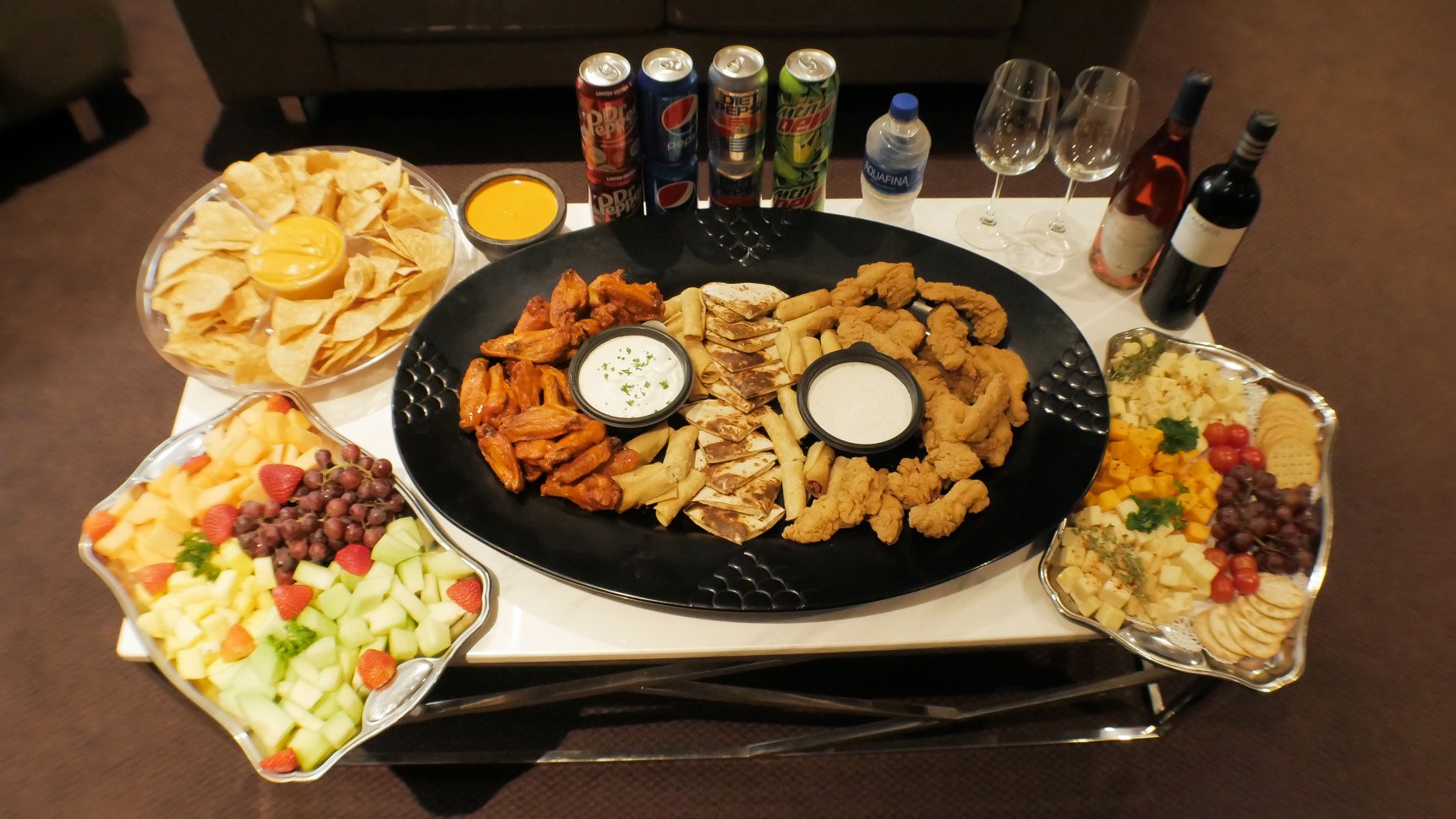 Top-down view of trays with beer, wine, and soda bottles
