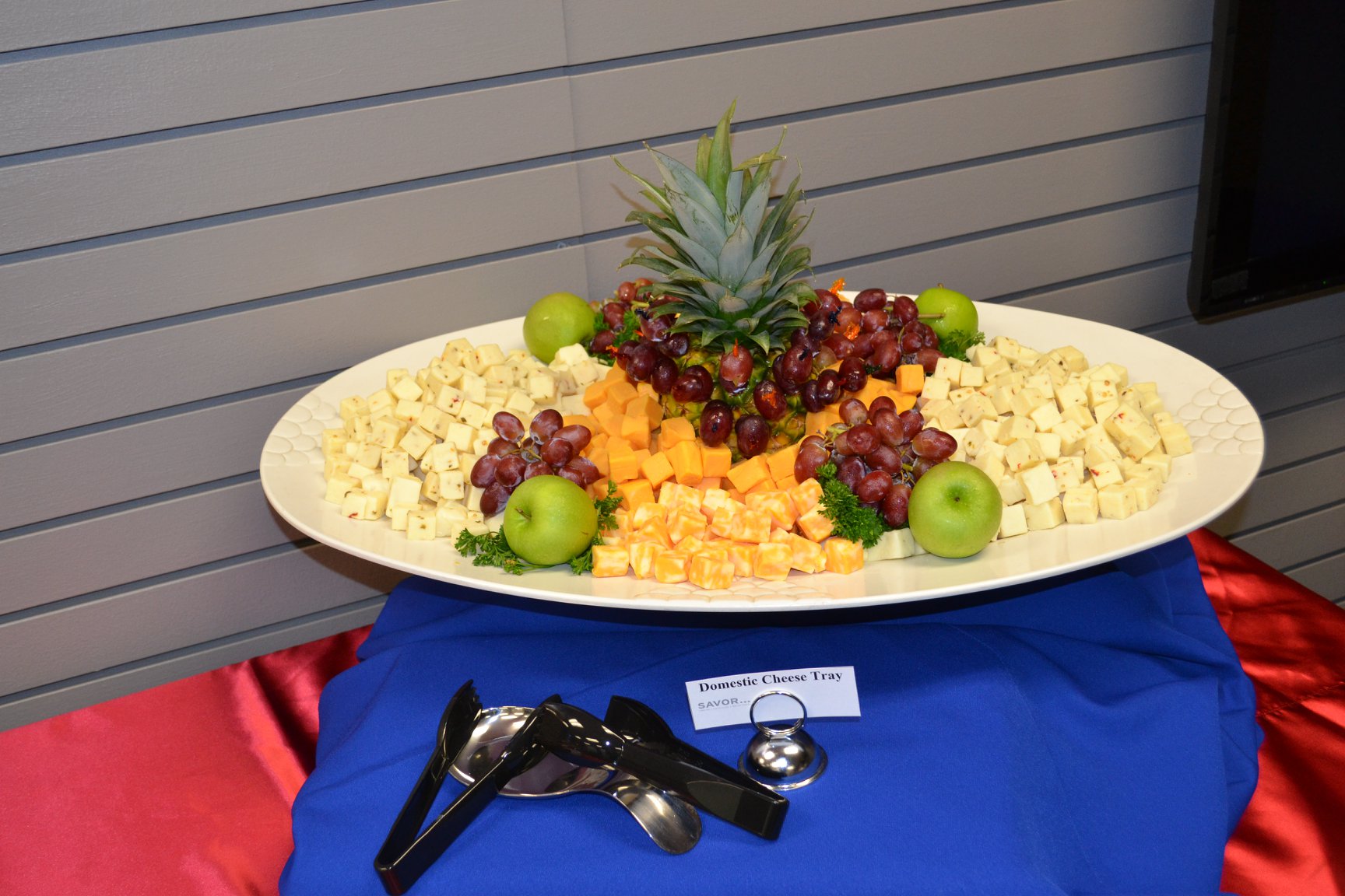 Assorted cheese tray with variety of cheeses served on a wooden board