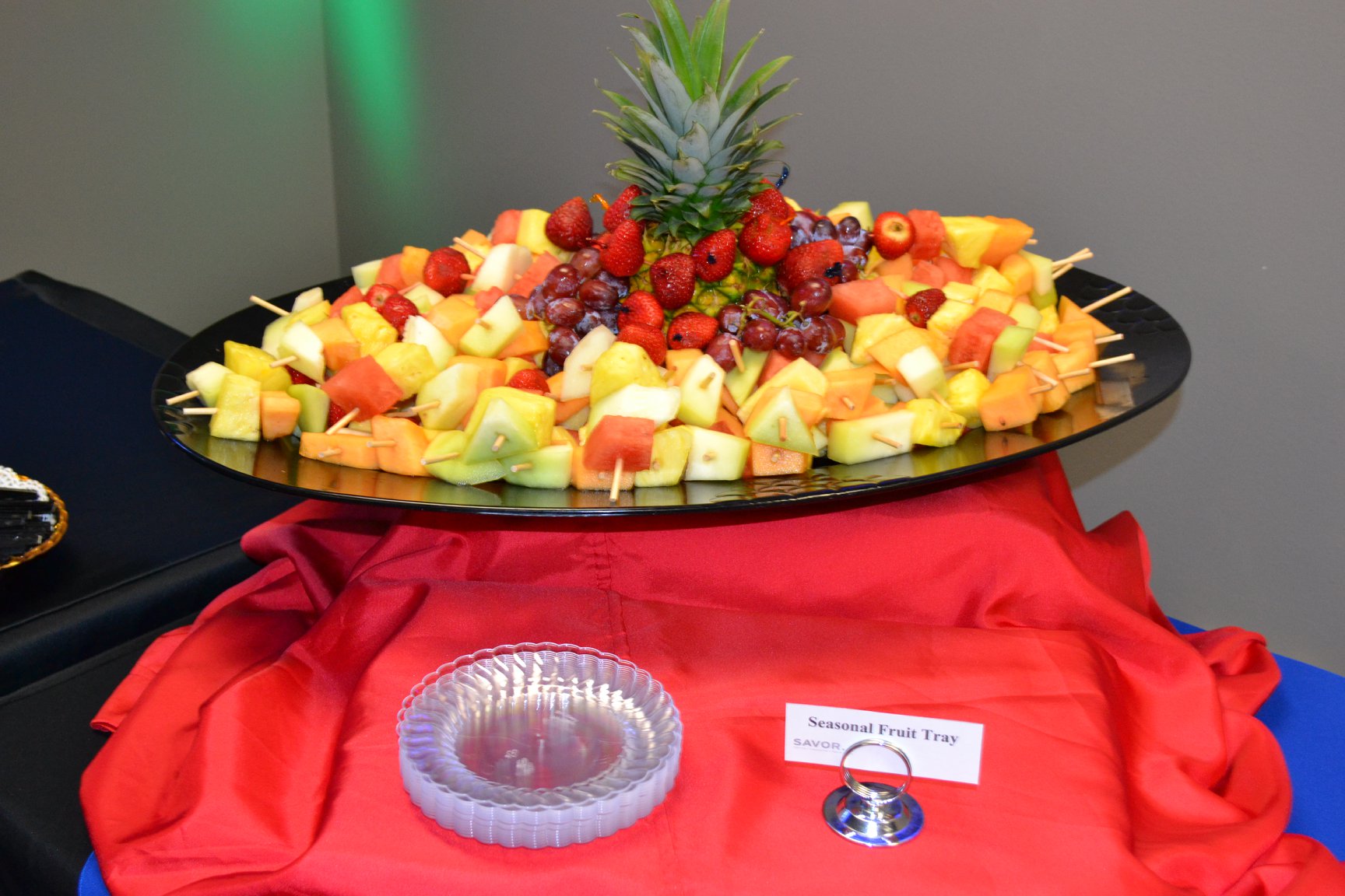 Fresh fruit tray with assorted sliced fruits including apples, strawberries, grapes, and oranges